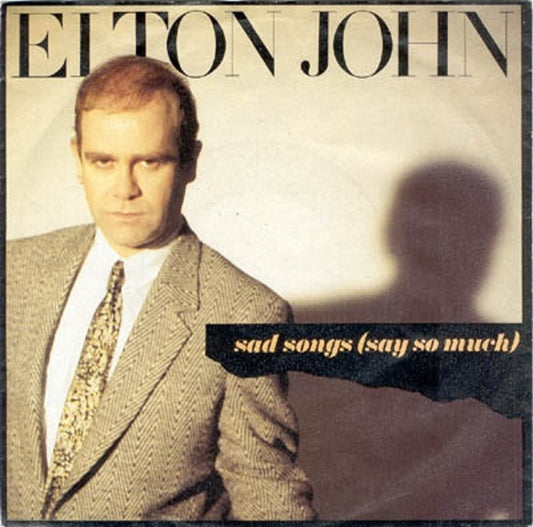 7" 45RPM Sad Songs (Say So Much)/A Simple Man by Elton John from The Rocket Record Company (PH 7)